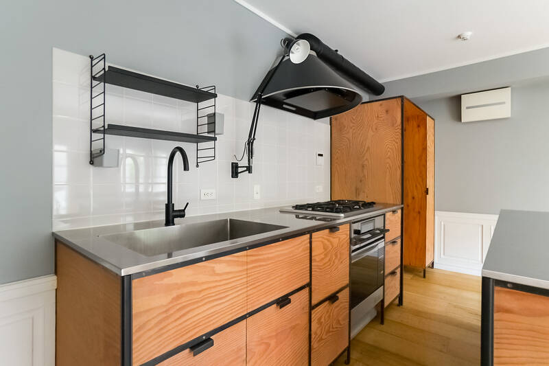 コンベクションオーブン付きのキッチン。ビンテージ感のある煙突のようなデザインのレンジフードは『アリエッタ』社製の『ジリオ』。