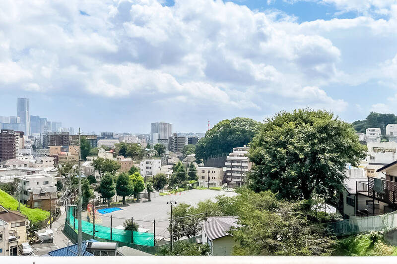 小学校の校庭や公園に、豊富なグリーン……そして左奥へ視線を向けると<b>横浜のビル群</b>が見えます！