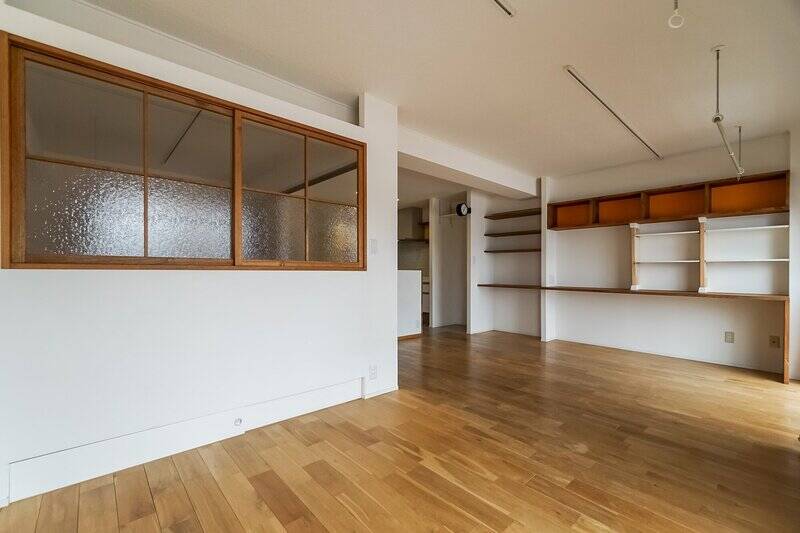 お隣の洋室Ａには、型ガラスをはめ込んだ開閉可能な室内窓が。右奥の壁面には、収納とデスクの機能を兼ね備えた造作カウンターが設えられています。うーん、あちこちに今っぽさを感じるアクセントが効いていますね。