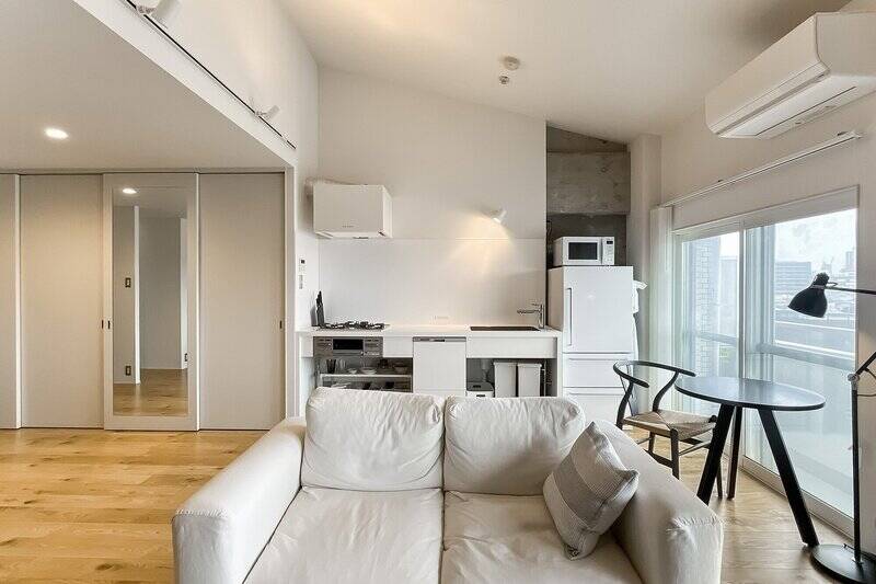 部分的に、躯体壁のコンクリートの素地が見えているのがアクセントで素敵…! 勾配天井部分によって空間の体積が大きくなるため、実際の面積よりも広く感じられます。