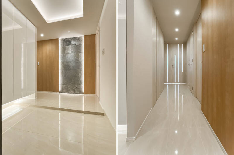 間接照明が効いたホワイト基調の玄関。正面には石調タイルがアクセントとして用いられています。スリットガラスが入ったドアを開け、LDKへ。