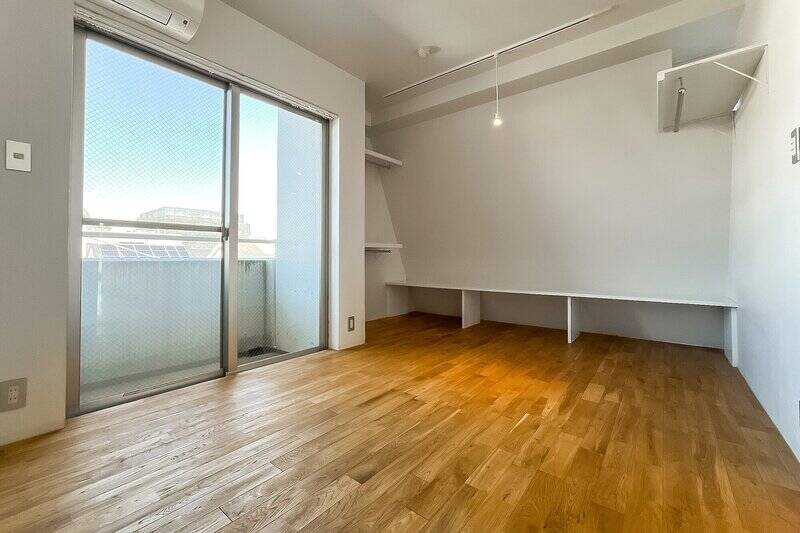 北西側のバルコニーに面した居室。一部の壁が勾配になっています。ハンガーパイプ付きのオープン収納が備わっていますよ。