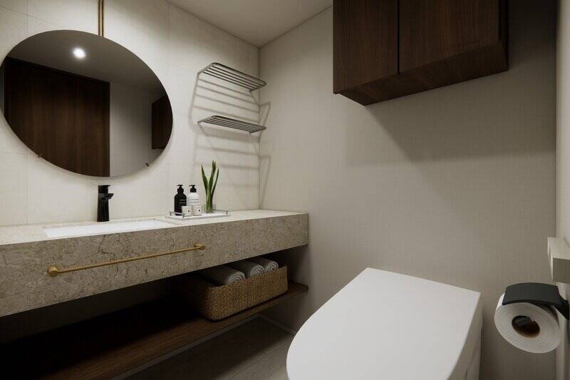 洗面台とトイレは2in1の間取り。大きな丸いミラーや、下部に収納を設けた広いカウンターなど、デザイン性の高い造りです。