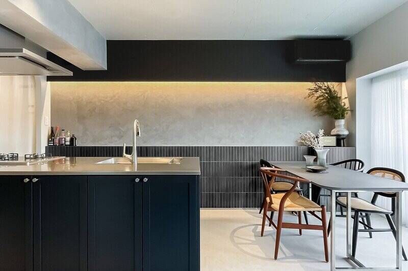 振り返って、ダイニングとキッチンをパシャリ。スリムなタイル、風合いのある塗装壁、キッチンの框組ドア……異なる材質が散りばめられていますが、色調が統一されていることにより、それぞれが空間に馴染みまとまっています。