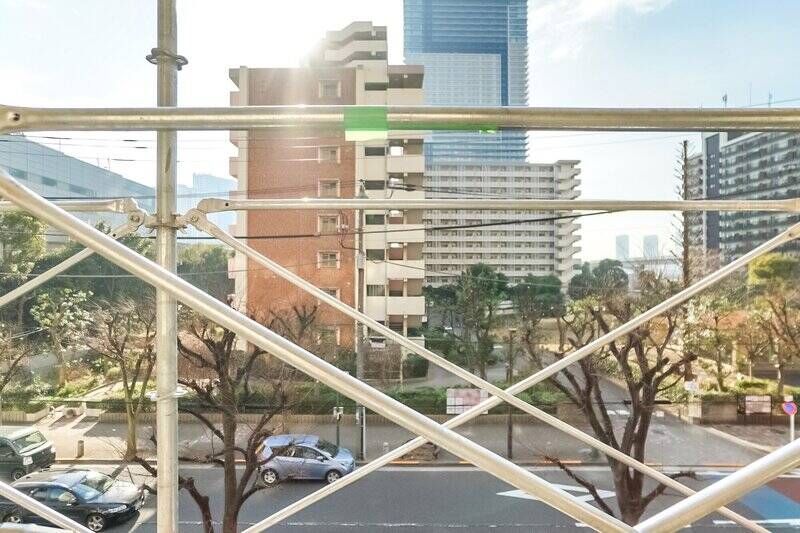 街路樹と道ゆく人々を見下ろす、穏やかな眺望。道路を挟んで斜め向かいには「豊洲五丁目公園」（徒歩1分）が見えます。