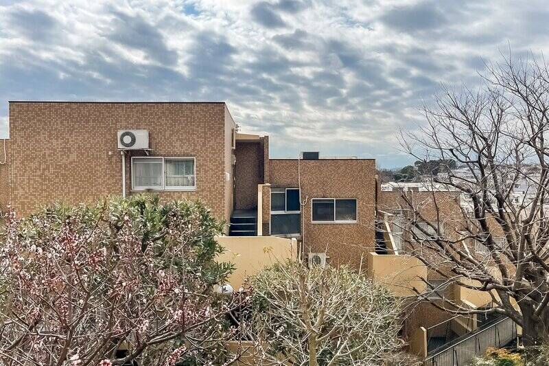 洋室B専用のバルコニーが付いています。木々を介して同マンションの別棟が見えるため、薄手のカーテンを閉めておくのがいいですね。