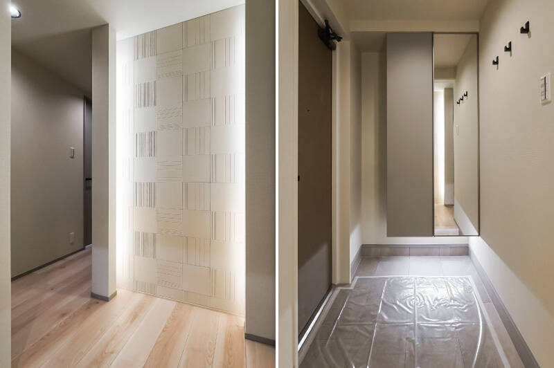 <b>左・</b>玄関正面の壁は間接照明入り。真ん中にアートなどを飾ると更に空間が引き締まりそう！／<b>右・</b>全身鏡が付いたシューズボックス。壁にフックがあるのは絶対に便利。なんでも引っ掛けてしまいそうです（笑）