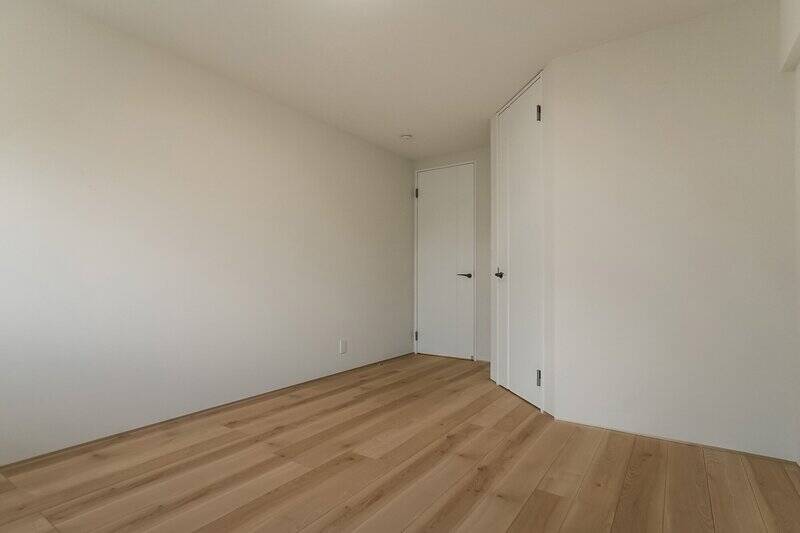 ダブルベッドを配置してもまだゆとりがありそうな洋室A。出入り口付近にウォークインクローゼット(WIC)を備えています。