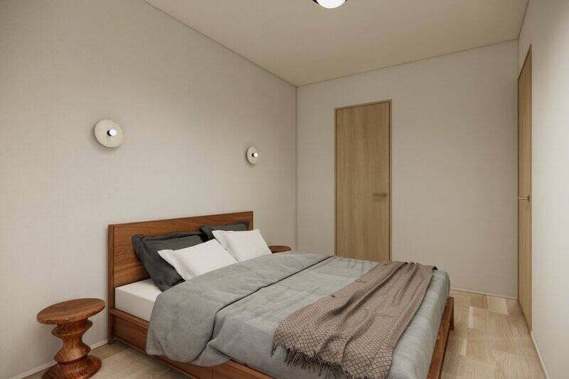 クイーンサイズのベッドを置いても、ゆとりがある広さの洋室A。ウォークインクローゼット（WIC）が備わっています。ブラケットライトもかわいらしい♪