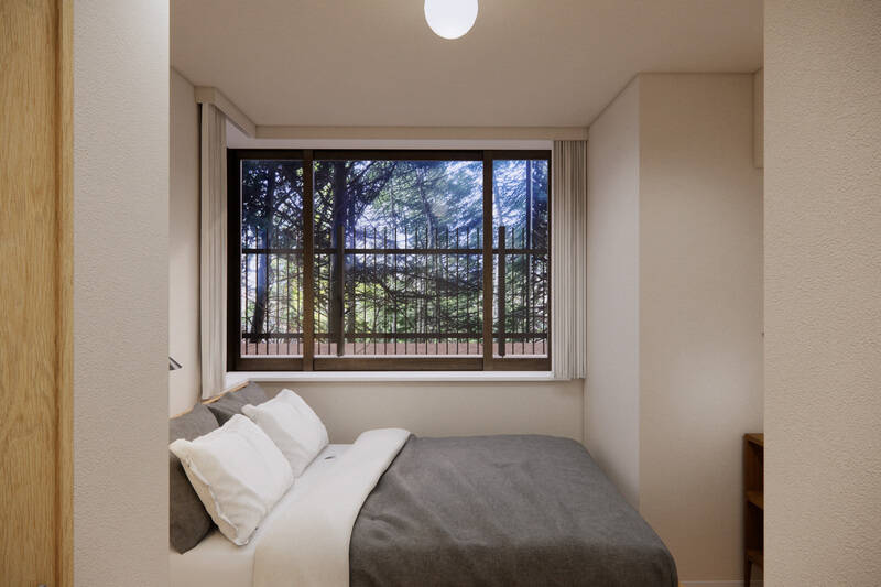 洋室Bは、セミダブルベッドが収まるサイズ感。窓からはテラスの緑を望みます。