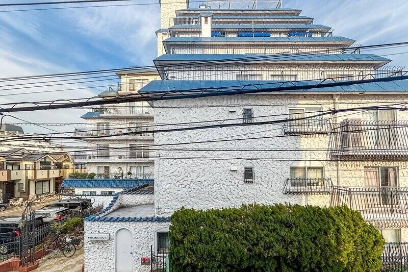 正面には、近くに建つ “秀和レジデンスシリーズ” のマンションの青い瓦屋根が見えます。