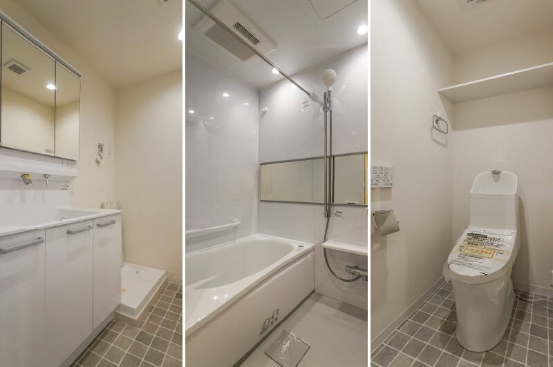 洗面室とトイレの足元には、住戸の雰囲気になじむグレーの床材を採用。1216サイズのユニットバスは、浴室乾燥機付きです。