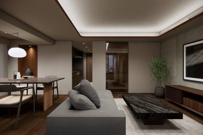 <p>廊下とLDKの間には、ブラウンガラスの建具を採用。光と視線がゆるやかにつながり、住まいの奥まで開放感をもたらしてくれます。リビングのアクセント壁には、自然素材の風合いを持つ凹凸感のある材質を使用。美しい陰影と経年変化が空間に深い静けさを演出します 。</p>